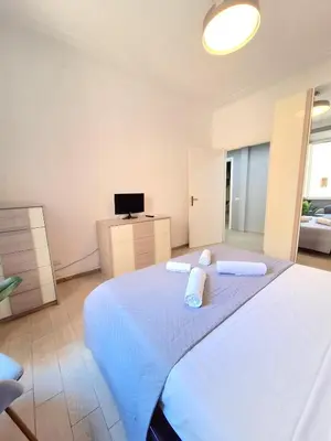a bedroom with a large bed with towels on it at Appartamento Tadolini in Rome