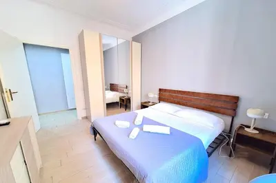 a bedroom with a bed with two books on it at Appartamento Tadolini in Rome