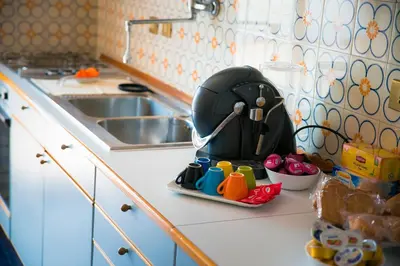 a kitchen counter with a mixer on a counter top at Plumbird Boutique & Apartment in Rome