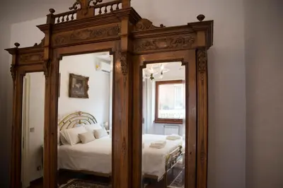 a mirror in the corner of a room with a bed at Plumbird Boutique & Apartment in Rome