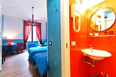 a bathroom with a bed and a sink in a room at Dream Station in Rome