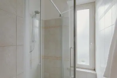 a shower with a glass door in a bathroom at Residenza Il Giglio in Rome