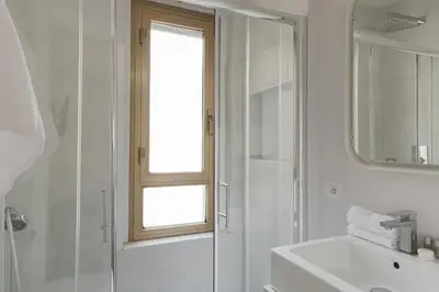 a bathroom with a shower and a sink and a mirror at Residenza Il Giglio in Rome