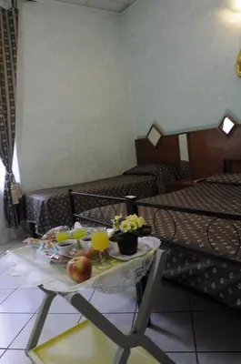 a room with a table with food and drinks on it at Hotel Farini in Rome
