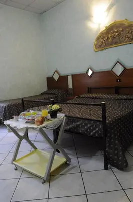 a room with a table with food and drinks on it at Hotel Farini in Rome