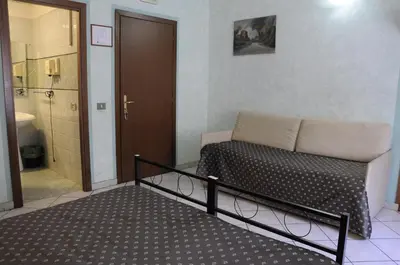 a bedroom with a bed and a walk in shower at Hotel Farini in Rome