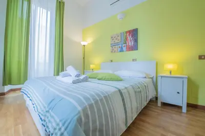 a bedroom with a bed with a blue and white blanket at Locanda Sant'Anna in Rome