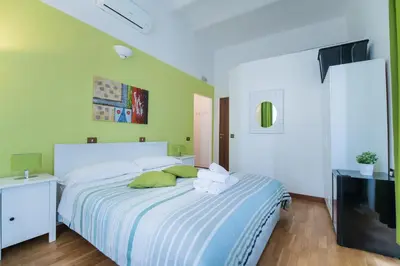 a bedroom with a bed with a colorful blanket at Locanda Sant'Anna in Rome
