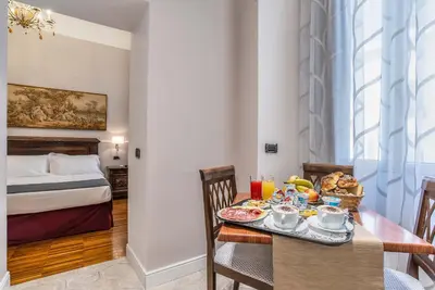 a dining room with a table with food on it at I TRE MOSCHETTIERI - D'ARTAGNAN Luxury Guest House in Rome