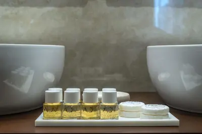 a group of four bottles of essential oils on a table at I TRE MOSCHETTIERI - D'ARTAGNAN Luxury Guest House in Rome