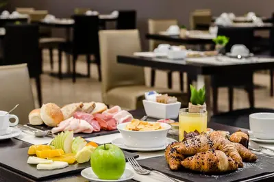 a table with food and drinks on it at Eurostars Roma Aeterna in Rome