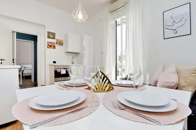 a dining room with a table with plates and wine glasses at Residenza Musei Vaticani in Rome
