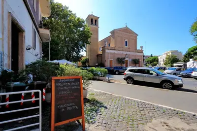 a sign in front of a church with a parking lot at Residenza Musei Vaticani in Rome