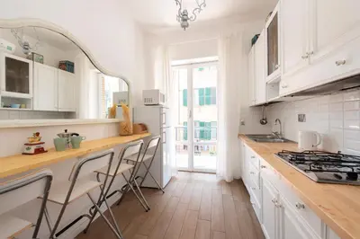 a kitchen with white cabinets and a counter top at Roma Chic Flat Monte Mario in Rome