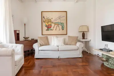 a living room with a white couch and a tv at Roma Chic Flat Monte Mario in Rome