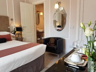 a bedroom with a bed and a chair and a mirror at Althea Inn Roof Terrace in Rome