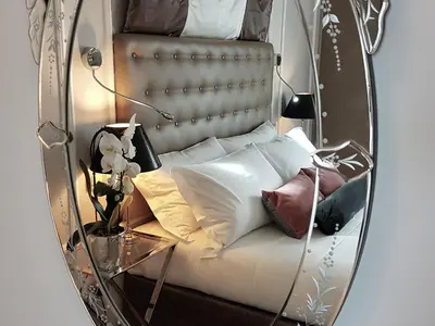 a mirror of a bed with pillows on it at Althea Inn Roof Terrace in Rome