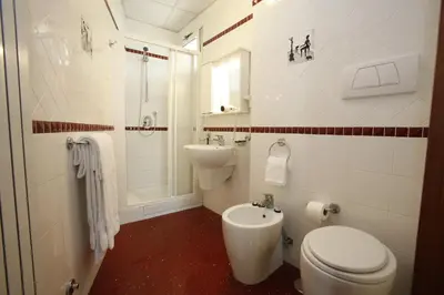a bathroom with a toilet and a sink at Hotel Adriatic in Rome