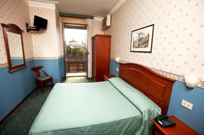 a hotel room with a bed and a window at Hotel Adriatic in Rome