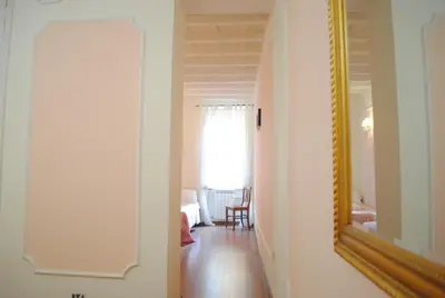 a hallway with a mirror and a room at Dreaming Navona Rooms in Rome