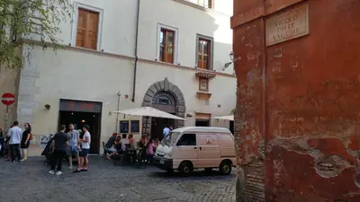 a group of people standing outside of a building at Dreaming Navona Rooms in Rome