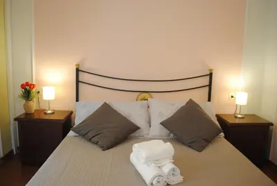 a bedroom with a bed with two towels on it at Dreaming Navona Rooms in Rome