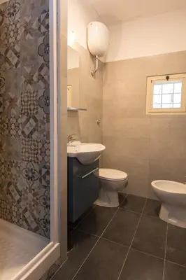a bathroom with a sink and a toilet and a shower at Seven Rooms Vatican in Rome