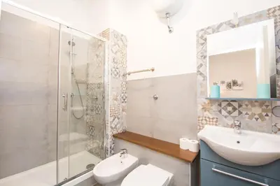 a bathroom with a sink toilet and a shower at Seven Rooms Vatican in Rome