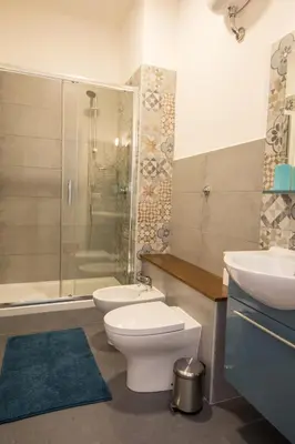a bathroom with a toilet and a sink and a shower at Seven Rooms Vatican in Rome