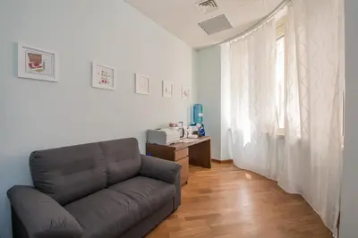 a living room with a couch and a table at Seven Rooms Vatican in Rome