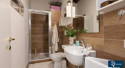 a bathroom with a toilet and a sink and a shower at L'Olimpo di Estia in Rome
