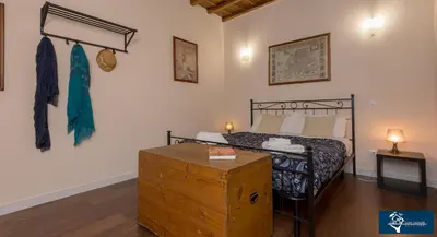 a bedroom with a bed and a wooden trunk at L'Olimpo di Estia in Rome