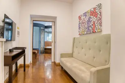 a living room with a couch and a desk at Orsoline Boutique Apartments - Best position in Rome in Rome