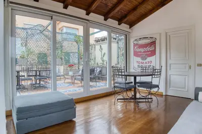 a room with a table and chairs and a patio at Orsoline Boutique Apartments - Best position in Rome in Rome