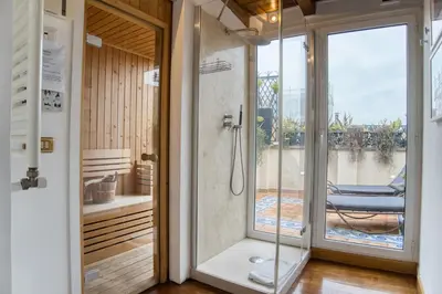 a bathroom with a shower with a glass door at Orsoline Boutique Apartments - Best position in Rome in Rome