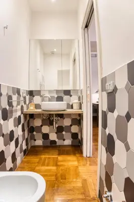a bathroom with a black and white tile wall at Orsoline Boutique Apartments - Best position in Rome in Rome
