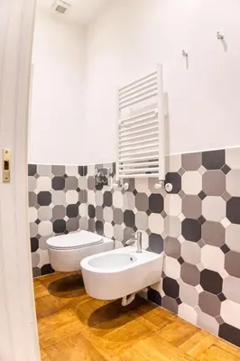 a bathroom with a sink and a toilet and a mirror at Orsoline Boutique Apartments - Best position in Rome in Rome