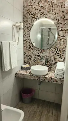 a bathroom with a sink and a mirror at Hotel PRINCIPE AMEDEO in Rome