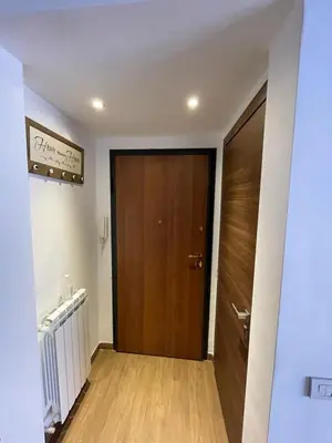 a hallway with a wooden door in a room at Casa Rosa in Rome