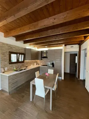 a kitchen and dining room with a table and chairs at Casa Rosa in Rome