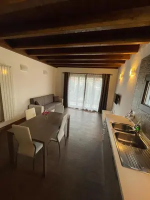 a kitchen and living room with a table and a couch at Casa Rosa in Rome