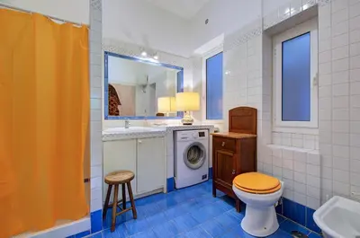 a bathroom with a toilet and a sink and a washing machine at Interno 9 a San Pietro in Rome