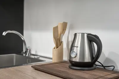 a kitchen counter with a tea kettle on a cutting board at Interno 9 a San Pietro in Rome