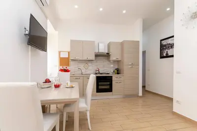 a kitchen with a table and a dining room at Amor Vatican Domus in Rome