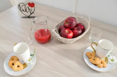 a table with plates of cookies and a basket of apples at Amor Vatican Domus in Rome