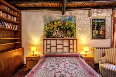 a bedroom with a bed and a painting on the wall at Magenta Collection Egidio in Rome