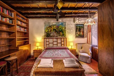 a bedroom with a bed and a book shelf at Magenta Collection Egidio in Rome