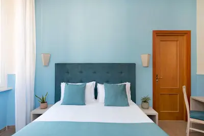 a blue bedroom with a large bed with blue walls at Hotel Parker - Gruppo BLAM HOTELS in Rome