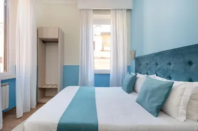 a blue and white bedroom with a large bed at Hotel Parker - Gruppo BLAM HOTELS in Rome