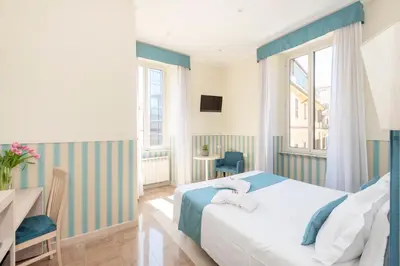 a hotel room with a bed and a desk at Hotel Parker - Gruppo BLAM HOTELS in Rome